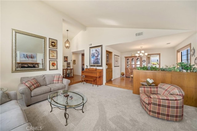 carpeted living area featuring vaulted ceiling, visible vents, and a chandelier