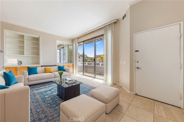 tiled living room with visible vents and baseboards