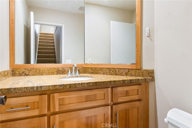 half bathroom with toilet and vanity