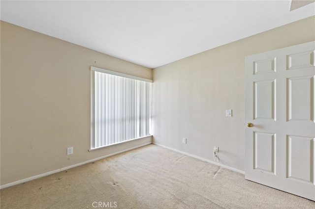 unfurnished room featuring baseboards and carpet flooring