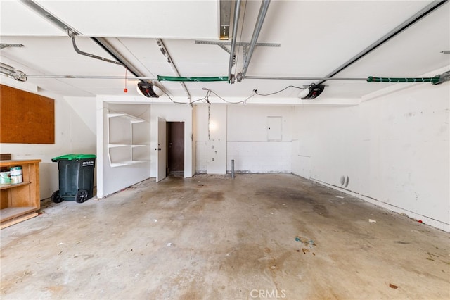 garage featuring electric panel and a garage door opener