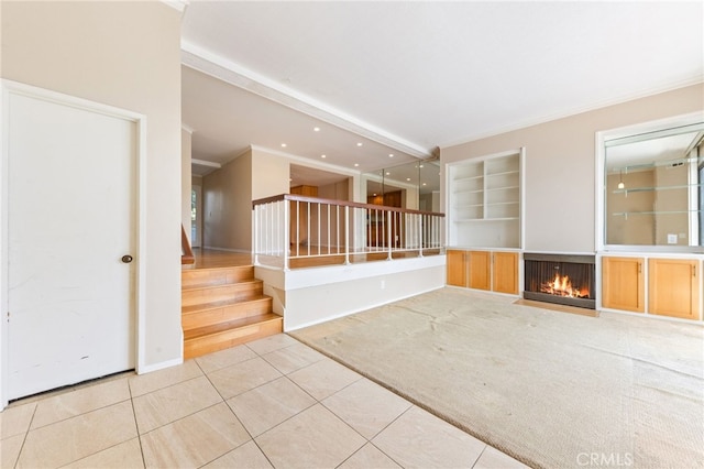 spare room with light carpet, built in features, stairway, light tile patterned floors, and a multi sided fireplace