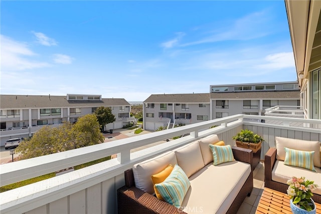 balcony with a residential view and an outdoor hangout area