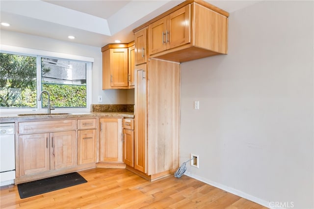 kitchen with recessed lighting, light wood-style floors, white dishwasher, and a sink