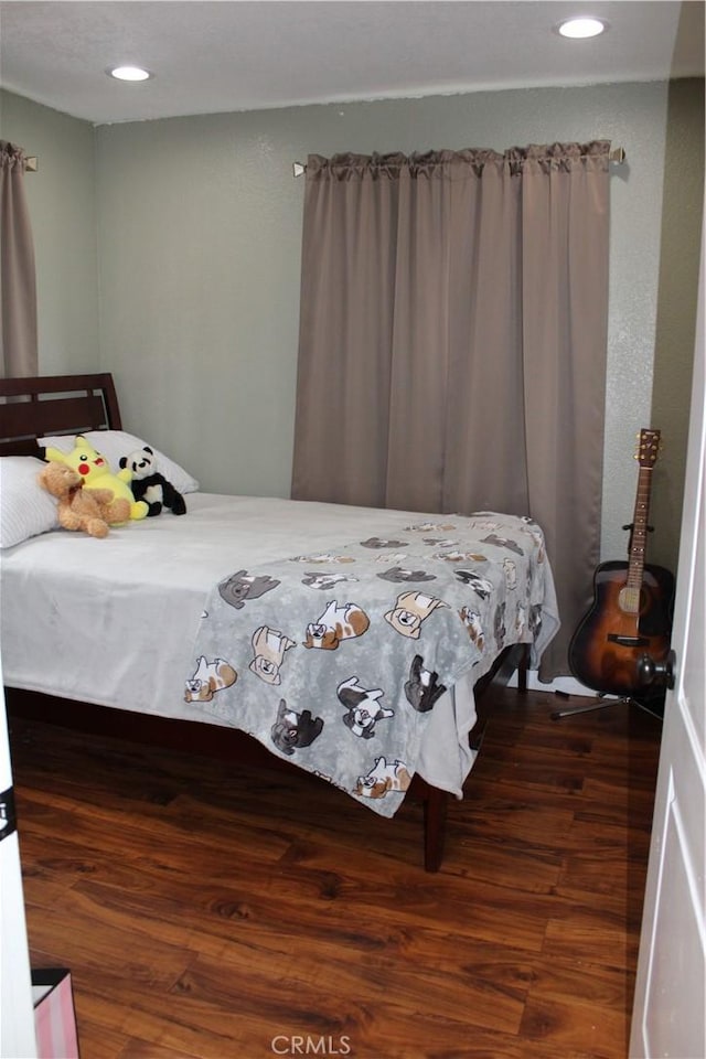 bedroom with recessed lighting and wood finished floors