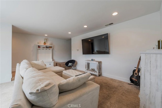 carpeted living area featuring recessed lighting, visible vents, and baseboards