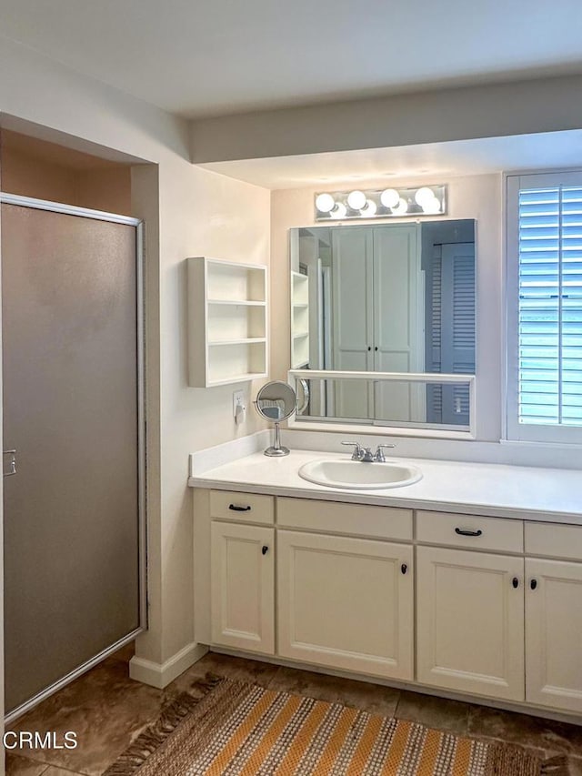 full bath with tile patterned floors, an enclosed shower, and vanity