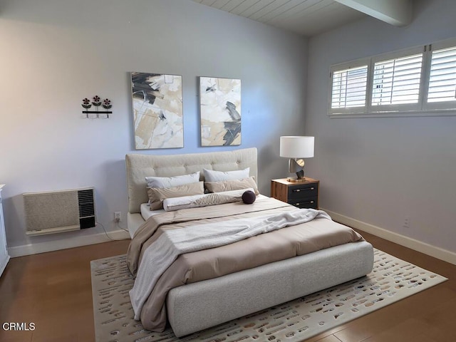 bedroom featuring beam ceiling and baseboards