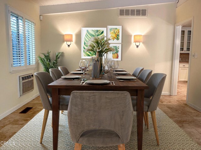 dining space with baseboards, visible vents, and a wall mounted air conditioner