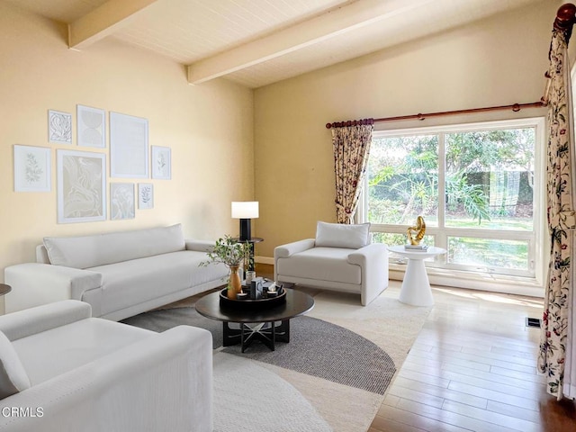 living room with beam ceiling, visible vents, and hardwood / wood-style floors