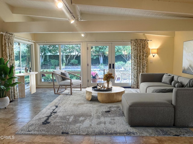 living area with beam ceiling, rail lighting, and french doors