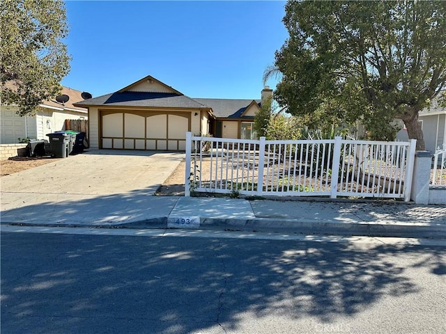 view of front of house featuring concrete driveway, a garage, a fenced front yard, and a chimney