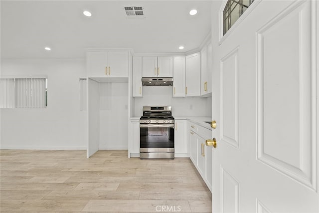 kitchen featuring under cabinet range hood, recessed lighting, light wood-type flooring, and stainless steel gas range