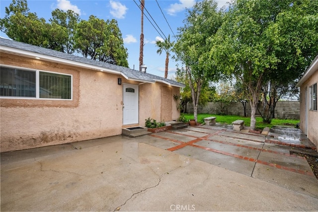 exterior space with a fenced backyard and entry steps