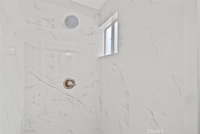 full bath with a marble finish shower