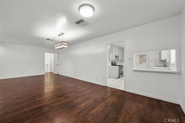 interior space featuring visible vents, wood finished floors, and a sink