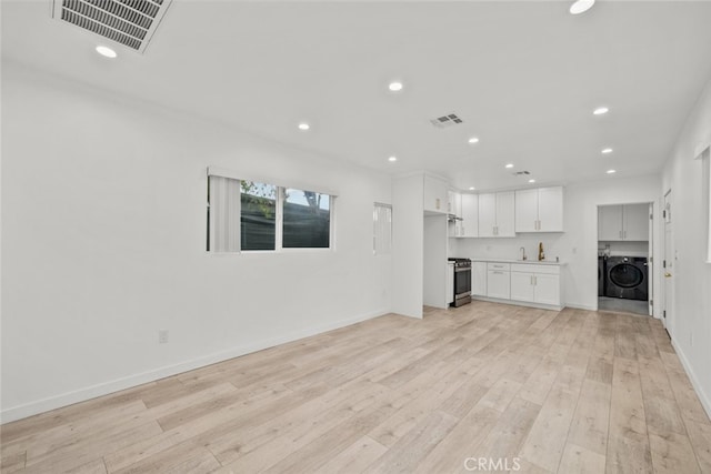 unfurnished living room featuring light wood-type flooring, visible vents, and recessed lighting