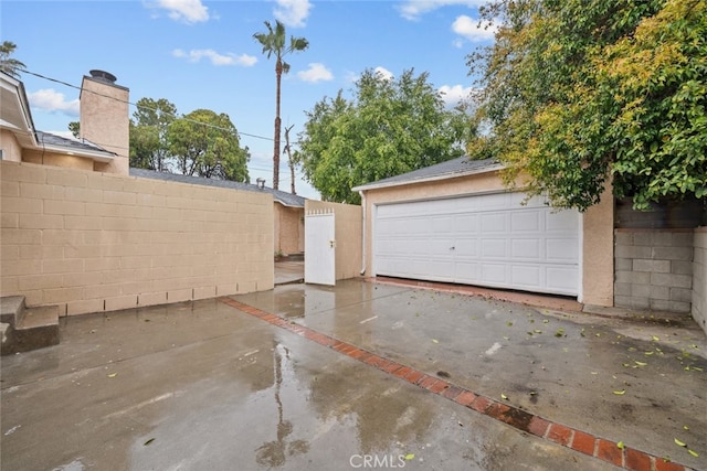 detached garage featuring fence