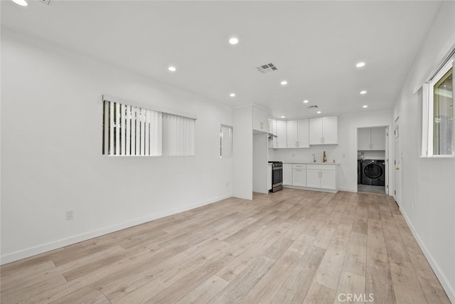 unfurnished living room with baseboards, visible vents, washer / clothes dryer, recessed lighting, and light wood-type flooring