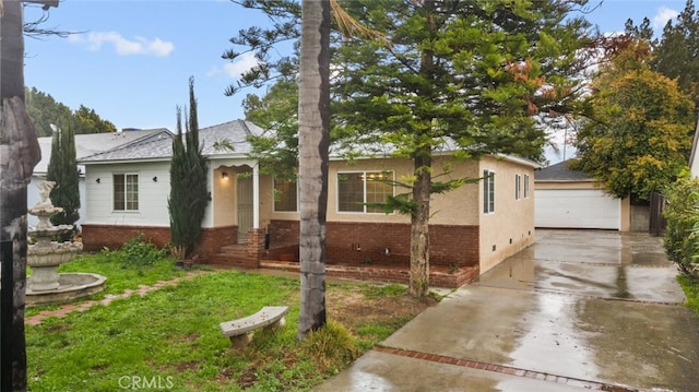 ranch-style house with brick siding, crawl space, a detached garage, and an outdoor structure