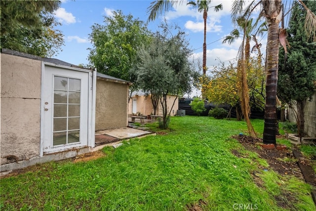 view of yard with an outbuilding and a fenced backyard