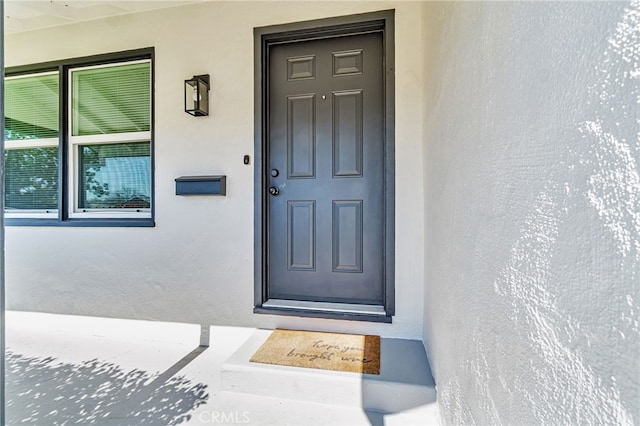 doorway to property with stucco siding