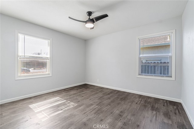 empty room with wood finished floors, baseboards, and ceiling fan