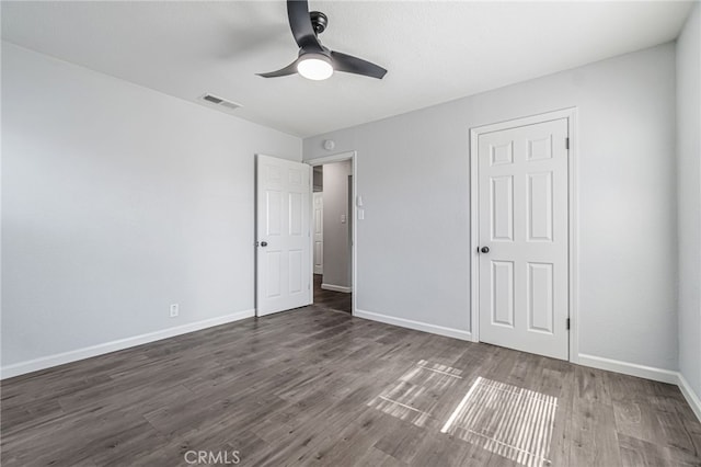 unfurnished bedroom with ceiling fan, wood finished floors, visible vents, and baseboards