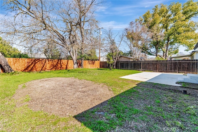 view of yard with a fenced backyard and a patio