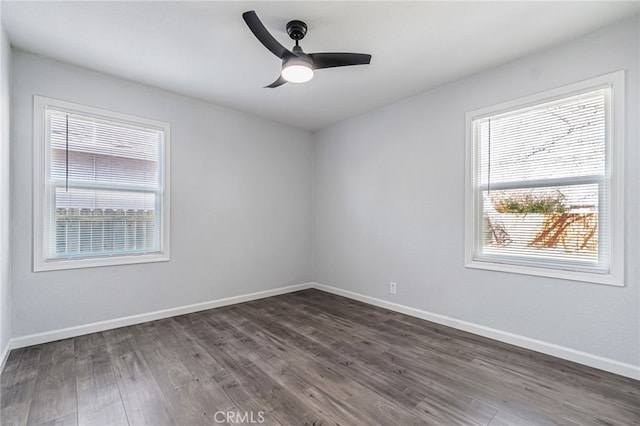 unfurnished room featuring baseboards, ceiling fan, and dark wood-style flooring