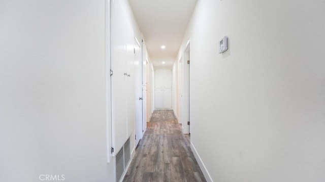 hall featuring visible vents, recessed lighting, wood finished floors, and baseboards