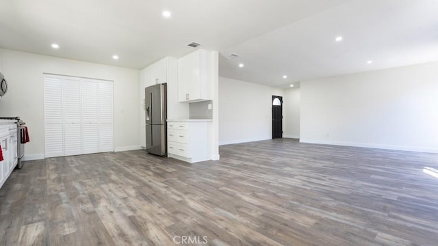 unfurnished living room with visible vents, recessed lighting, wood finished floors, and baseboards