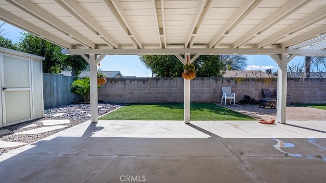 view of patio / terrace featuring a storage shed, an outbuilding, and a fenced backyard