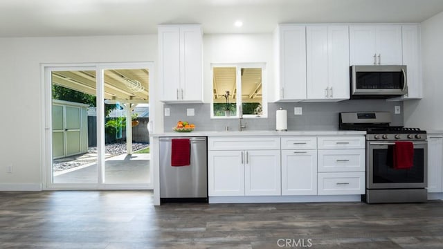 kitchen featuring a sink, stainless steel appliances, white cabinets, and light countertops