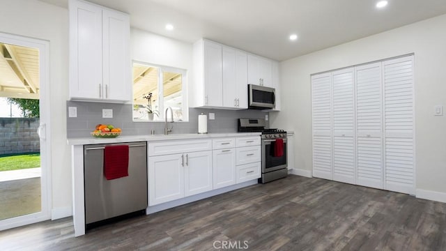 kitchen featuring a sink, stainless steel appliances, backsplash, and light countertops