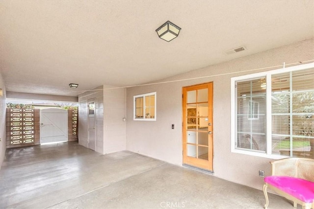 view of patio / terrace featuring visible vents and a gate