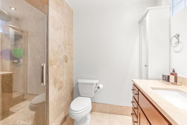 bathroom featuring toilet, a stall shower, vanity, and tile patterned flooring