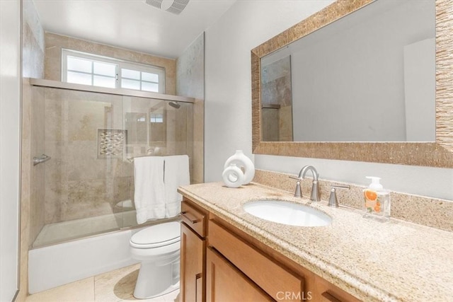 bathroom with tile patterned floors, visible vents, toilet, bath / shower combo with glass door, and vanity