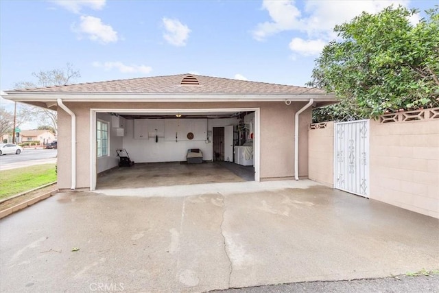 detached garage featuring fence