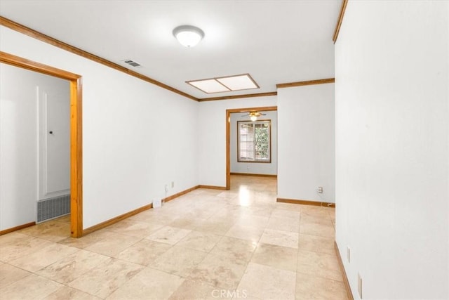 spare room with visible vents, baseboards, and ornamental molding