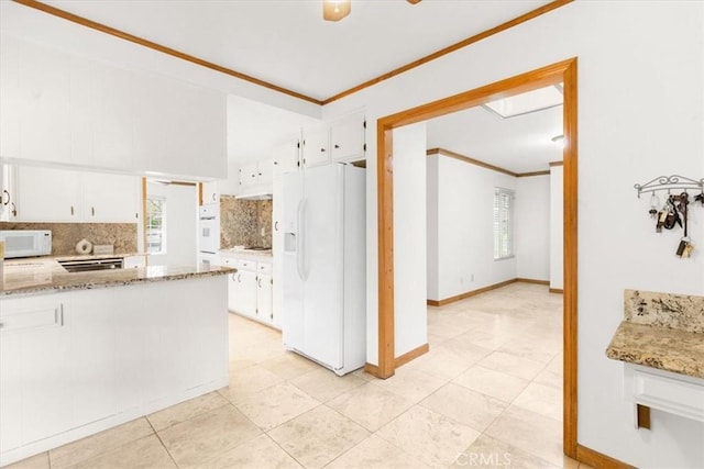 kitchen featuring tasteful backsplash, white appliances, white cabinetry, and crown molding