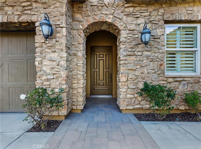 view of exterior entry with stone siding