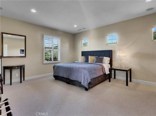 bedroom with baseboards, multiple windows, and carpet