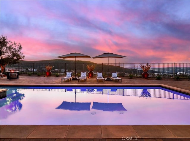 view of pool with a fenced in pool and fence