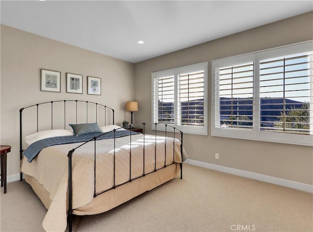 bedroom with baseboards, recessed lighting, and carpet