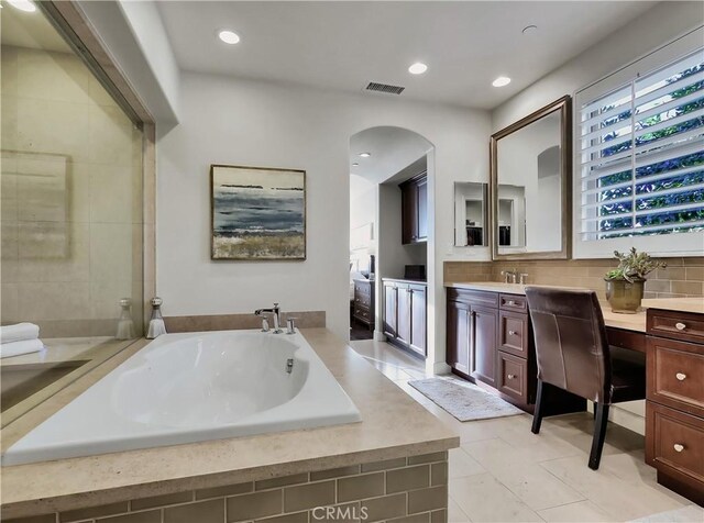 bathroom with visible vents, a garden tub, decorative backsplash, recessed lighting, and vanity