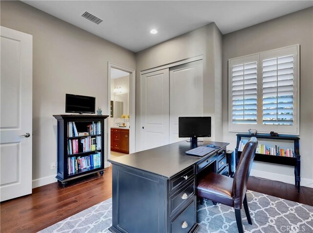 home office featuring visible vents, recessed lighting, dark wood-style flooring, and baseboards