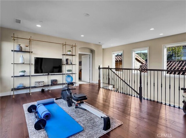 workout room with wood-type flooring, recessed lighting, and visible vents
