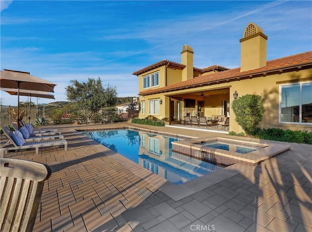 view of pool featuring an outdoor living space, a pool with connected hot tub, ceiling fan, fence, and a patio