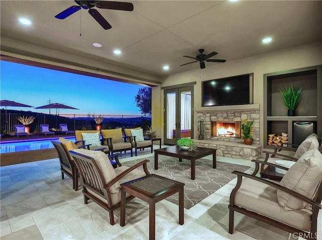 view of patio / terrace featuring an outdoor living space with a fireplace, fence, and a fenced in pool